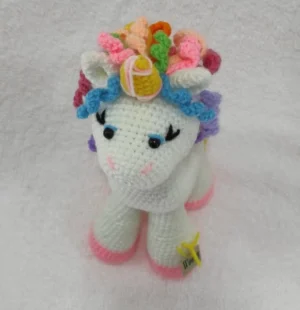 A close-up image of the Woovy Crochet Unicorn, showing its intricate crochet design and pastel colour theme.