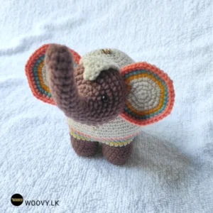 Handcrafted Sri Lankan Kandyan elephant plush ornament with floppy ears and raised trunk.