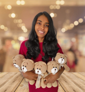 Smiling woman holding handmade crochet teddy bears – amigurumi plush toys from Sri Lanka